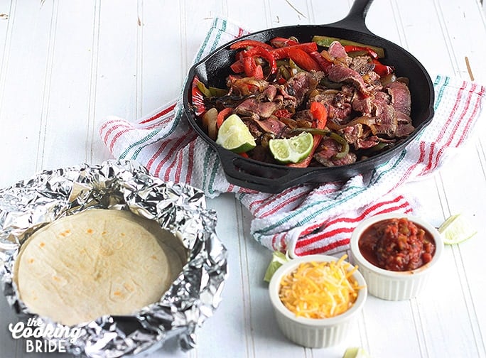 Tasty flat iron steak is marinated for up to 24 hours for maximum flavor. Serves this sizzling steak fajita recipe with sauteed vegetables and your fave toppings.