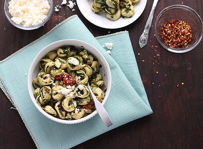 This tortellini sauce has a some Latin American flair. Tomatillos are roasted with garlic and olive oil, blended with fresh spinach and roasted tomatoes, then tossed with queso fresco cheese.