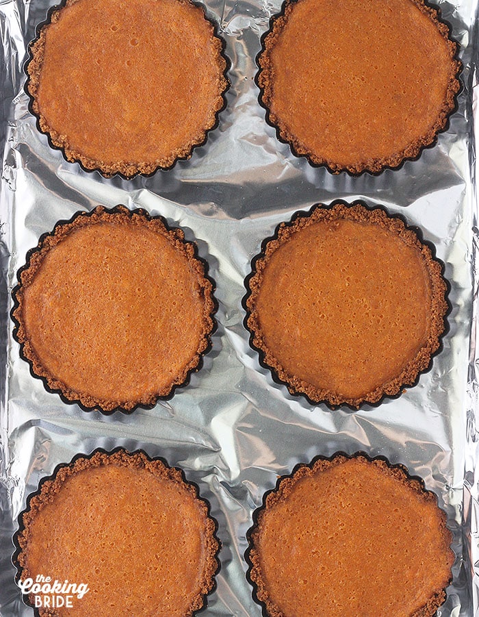 baked sweet potato tarts on a foil lined baking sheet