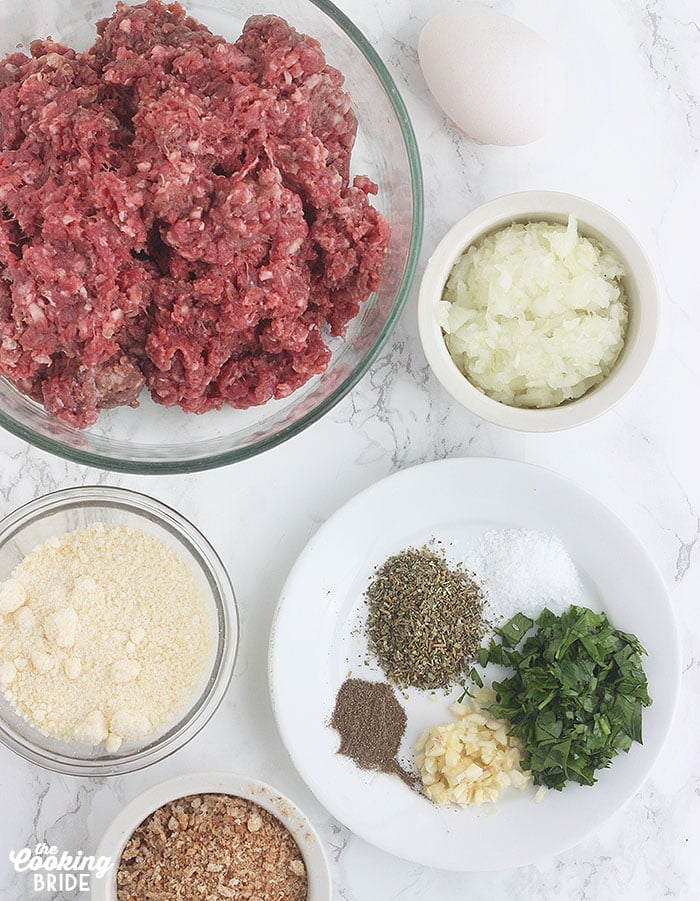 venison meatball ingredients including ground venison, Parmesan cheese, herbs, breadcrumbs and egg