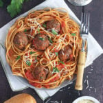 plate of pasta and tomato sauce topped with venison meatballs