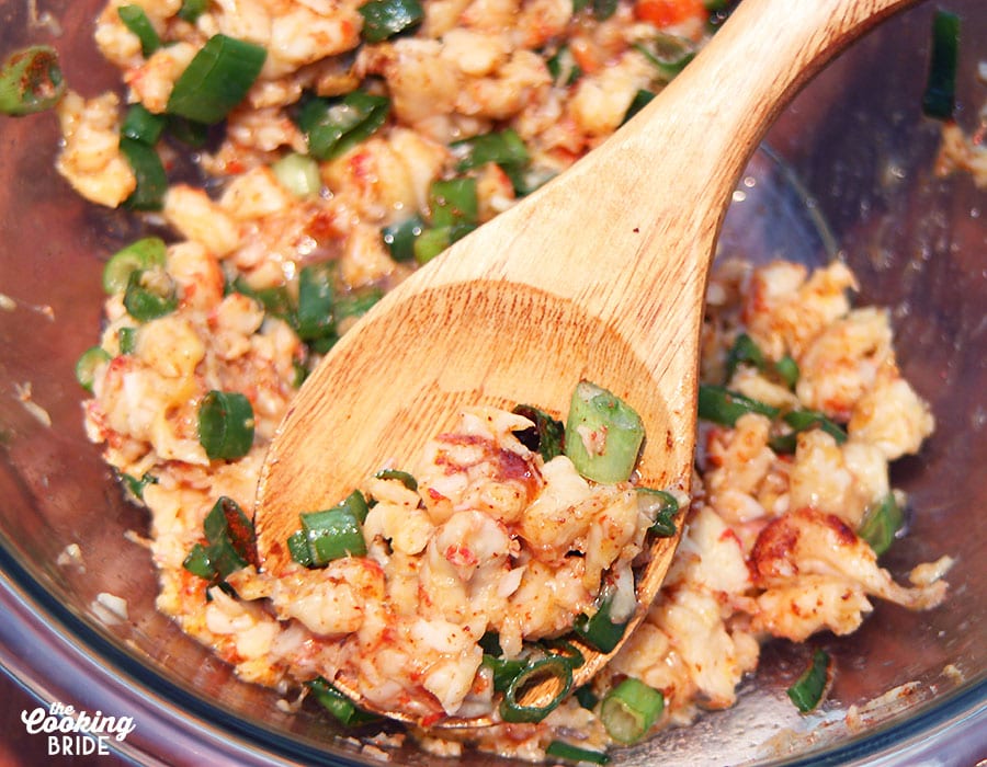 mixing crawfish meat with green onions and eggs