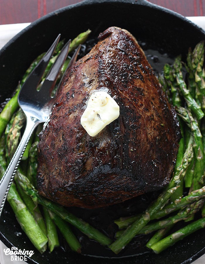 pat of butter melting on top of the cooked roast beef,