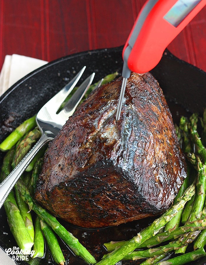 red Thermapen thermometer measuring the temperature of the cooked roast beef