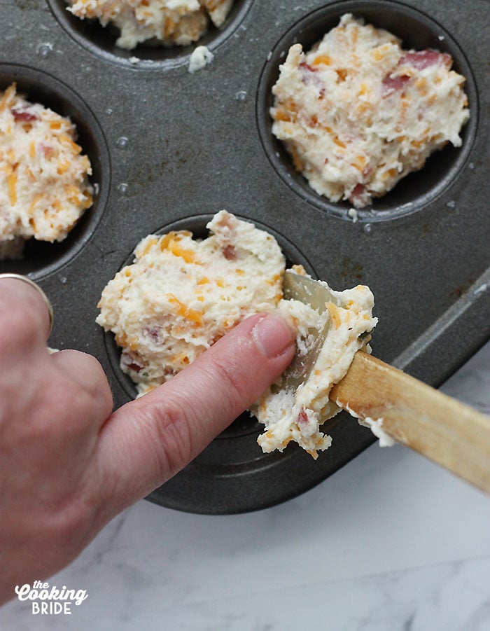 scooping the muffin batter into a mini muffin pan