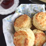 buttermilk biscuits in a basket lined with a floral napkin