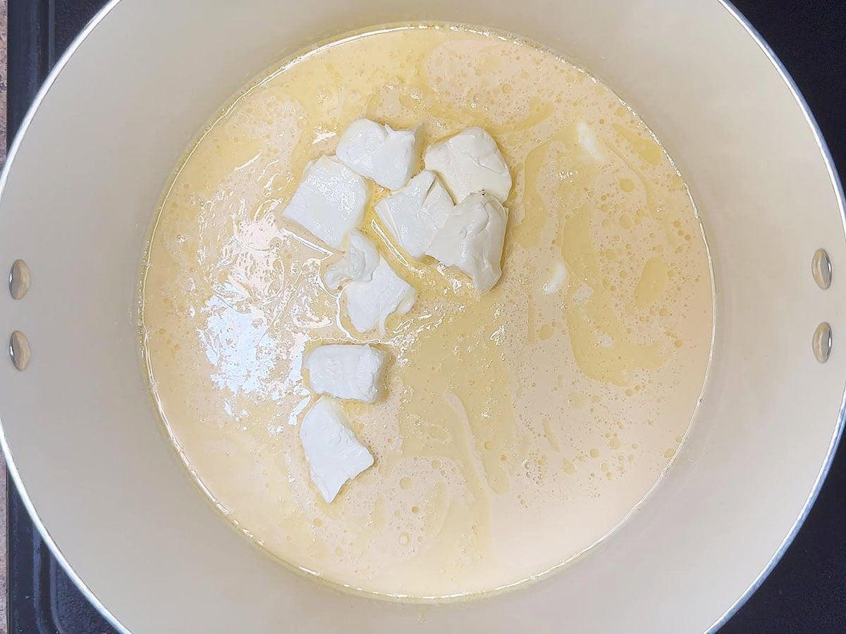 Cubed cream cheese added to the warmed evaporated milk.