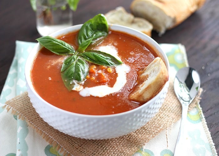 Warm up with the fresh flavors of this creamy tomato basil soup recipe. It's full of late summer bounty with fresh basil, sweet corn, and juicy tomatoes.