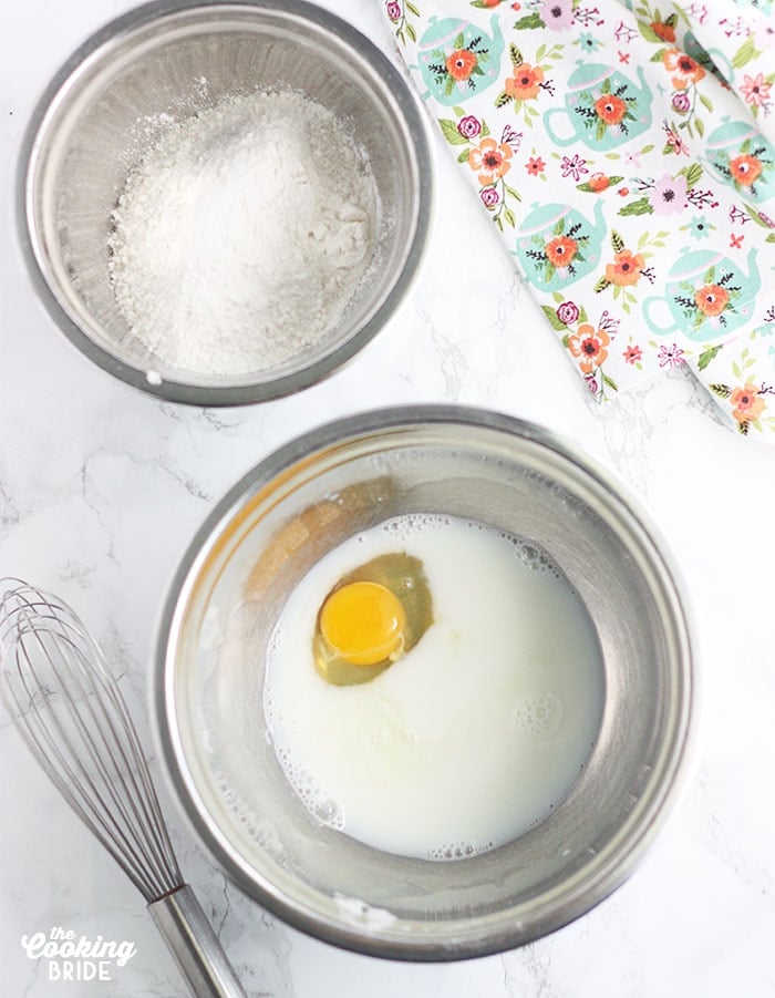 eggs and milk in a steel mixing bowl
