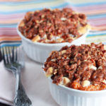 Sweet potato casserole is taken to the next level with coconut, bourbon, raisins, and a crunchy pecan brown sugar topping.