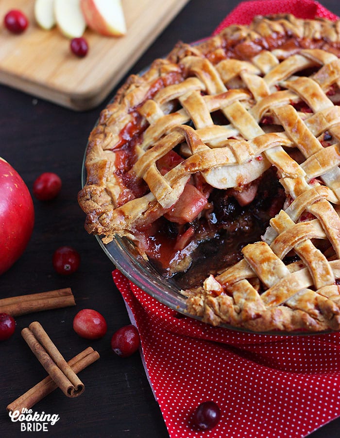 baked cranberry apple pie with a slice cut out
