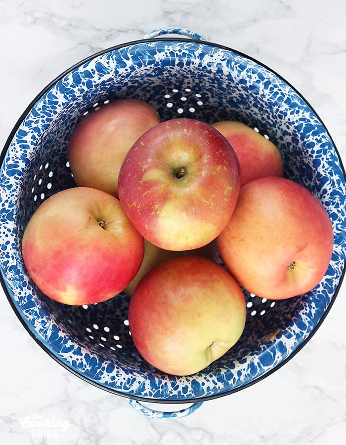 Fuji apples in a blue and white colander