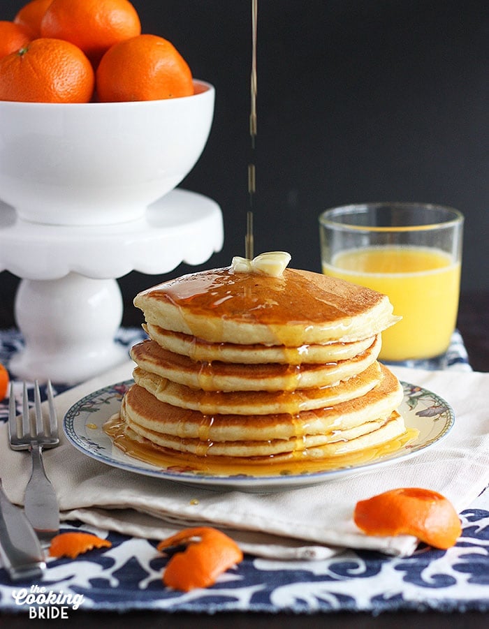 Serve these pillowy soft homemade buttermilk pancakes from scratch drizzled with homemade orange syrup for breakfast. They will melt in your mouth!