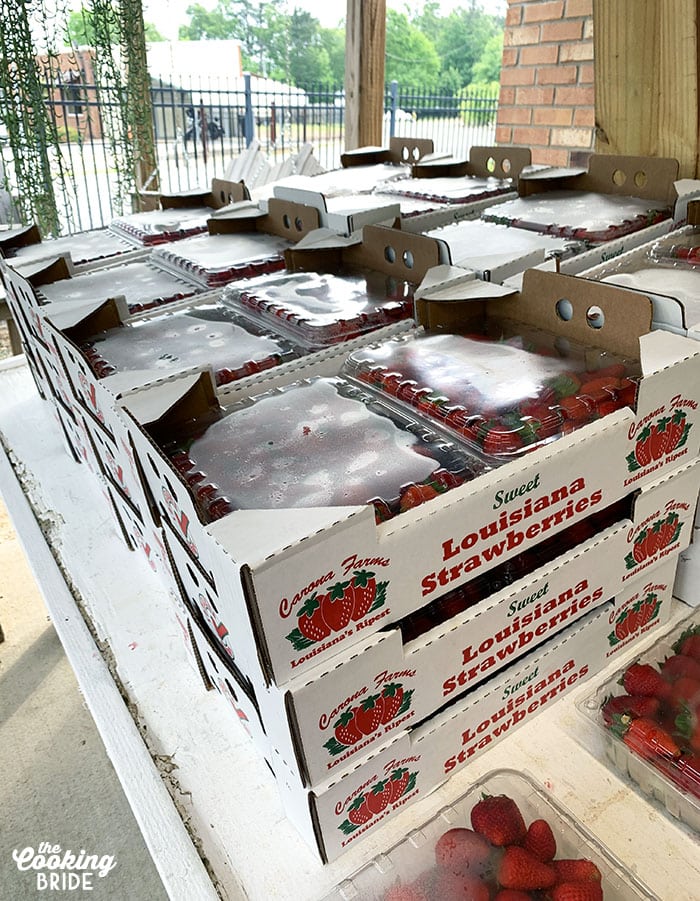 flats of Louisiana strawberries lined up on a table at a farmer's market