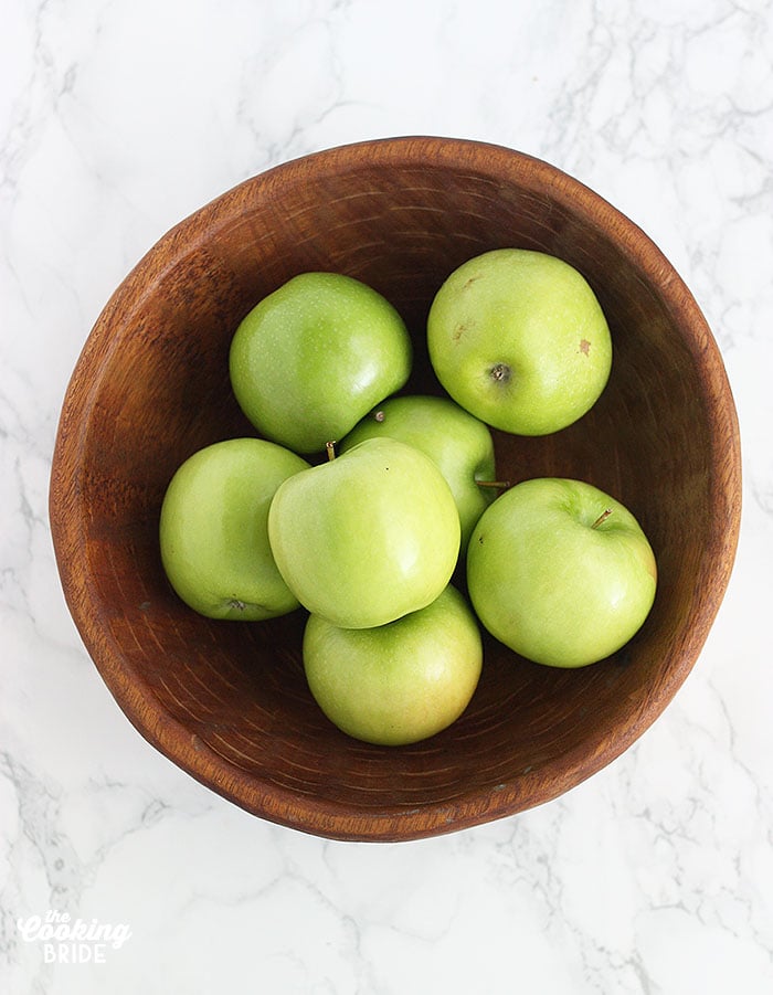 wooden bowl of granny smith apples