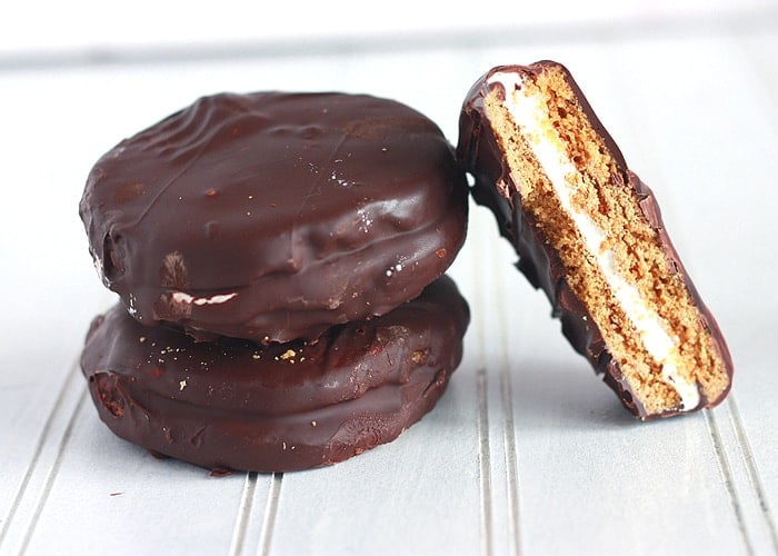 Homemade moon pies are a traditional Southern treat. Marshmallows are nestled between two graham cracker cookies and covered in chocolate.