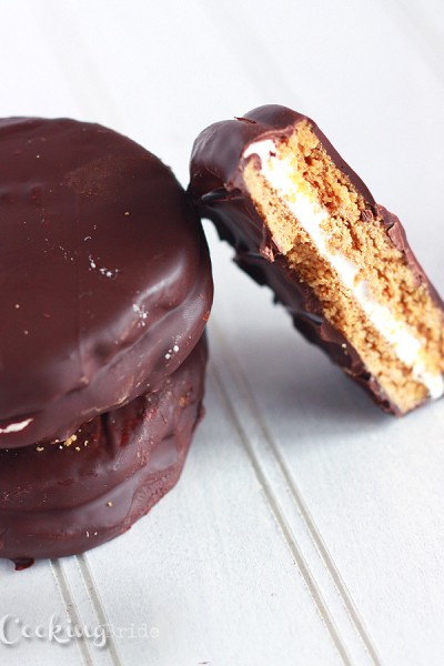 Homemade moon pies are a traditional Southern treat. Marshmallows are nestled between two graham cracker cookies and covered in chocolate.