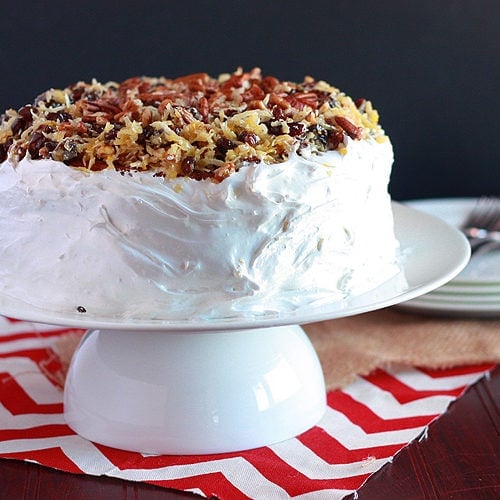 A forgotten Southern classic, Amalgamation cake is filled with raisins and coconut, iced with homemade frosting and garnished with more coconut and raisins.