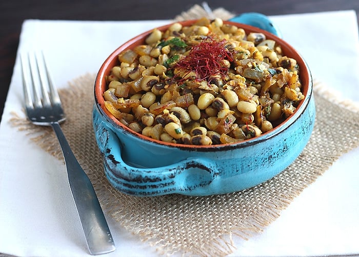 A Southern black eyed peas recipe gets a spicy kick from cumin, coriander, and saffron. Spice up your New Year's Day dinner with this tasty side dish.