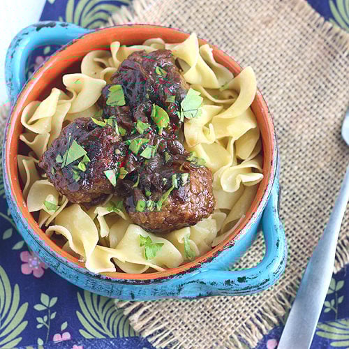 Tender beer braised pork meatballs are slowly simmer with thinly sliced onions in a dark stout gravy. Perfect comfort food!