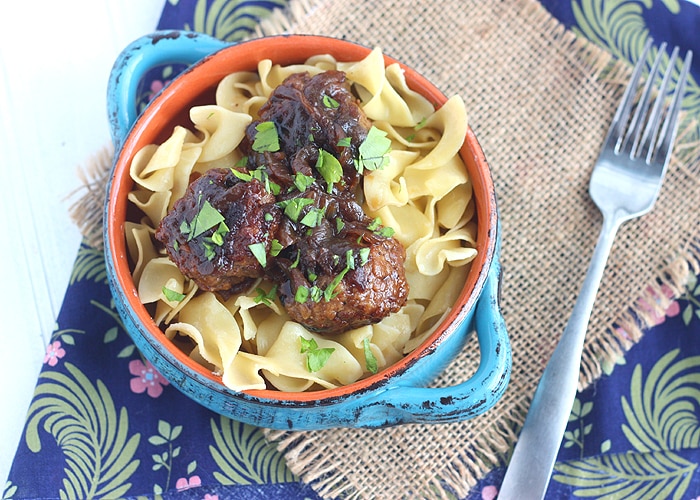 Tender beer braised pork meatballs are slowly simmer with thinly sliced onions in a dark stout gravy. Perfect comfort food!