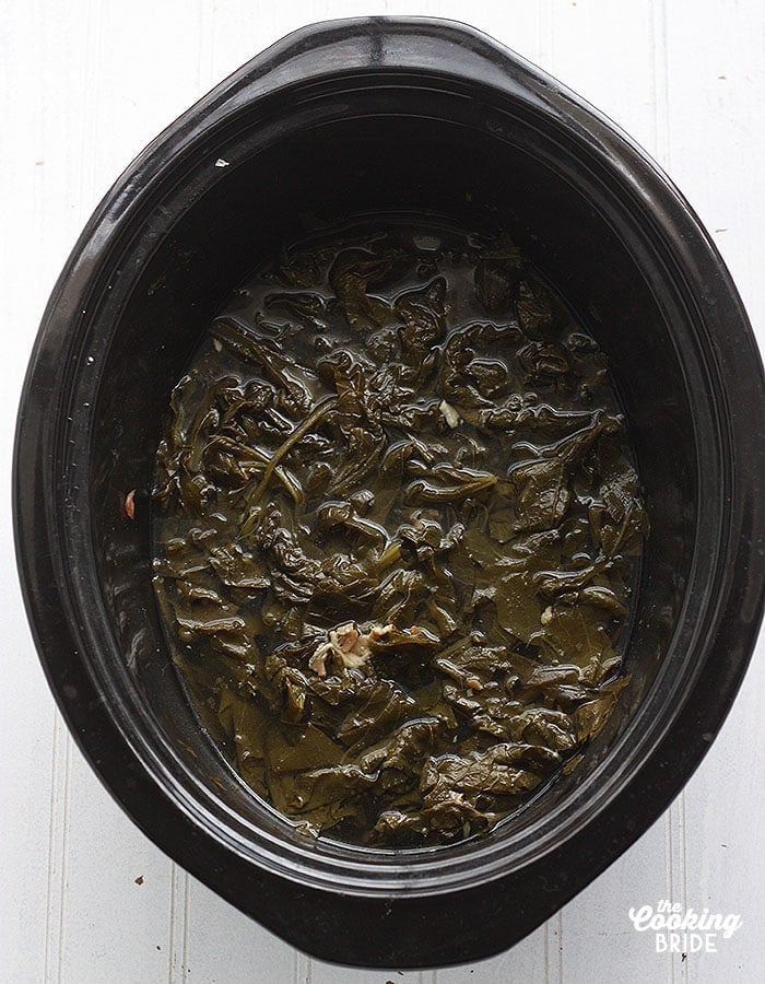 cooked collard greens in a slow cooker