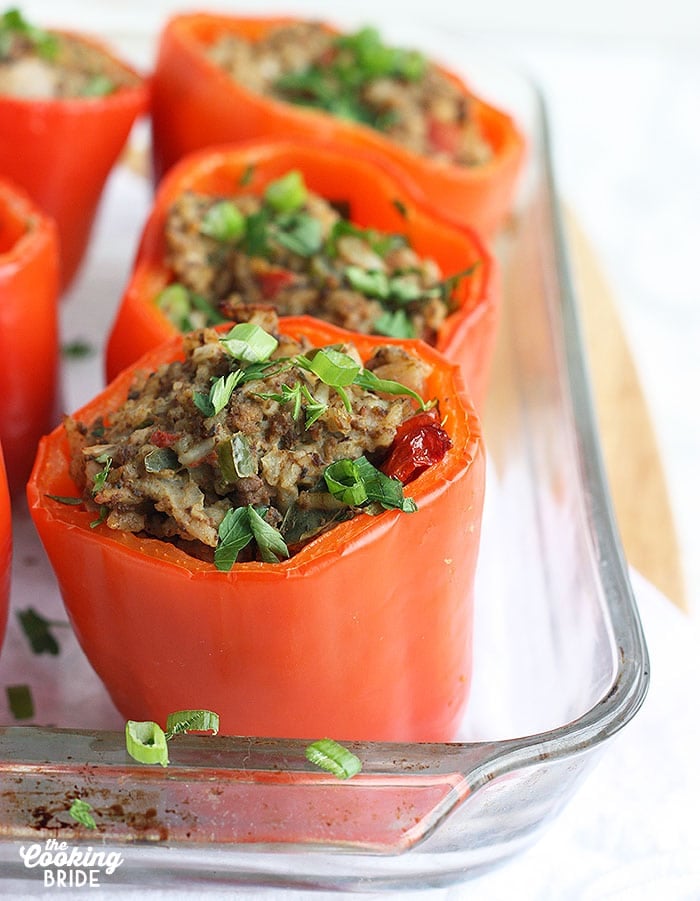 cooked stuffed bell peppers in a casserole dish