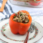 one stuffed bell pepper on a plate with a fork