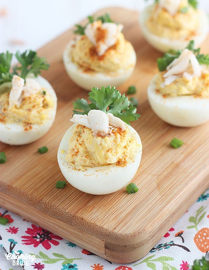 close up shot of crab deviled eggs on a wooden cutting board