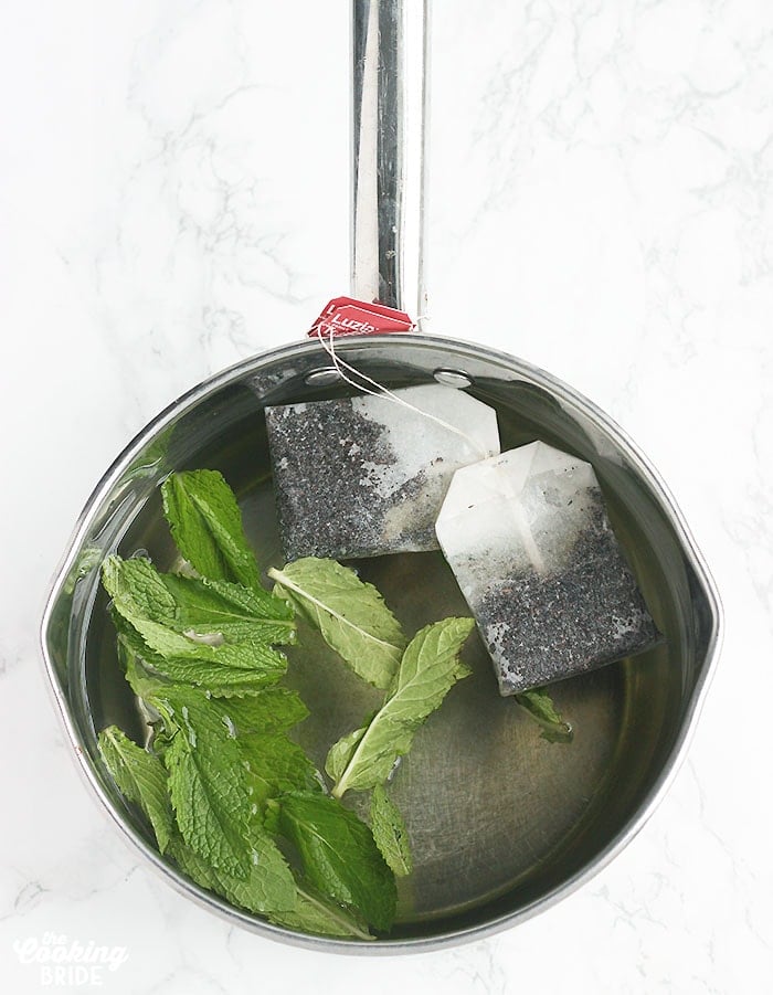 saucepan with tea bags, water and mint