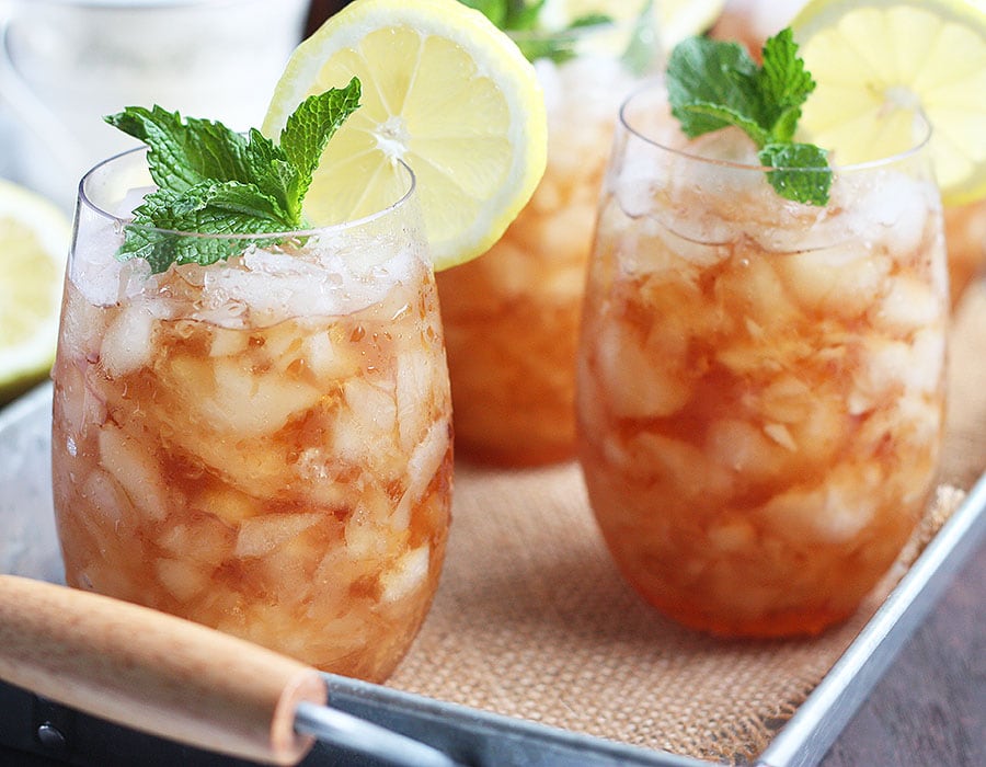 two sweet tea mint julep cocktails on a metal tray