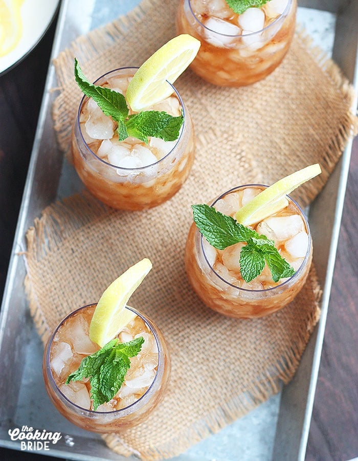 four sweet tea mint julep cocktails on a metal tray