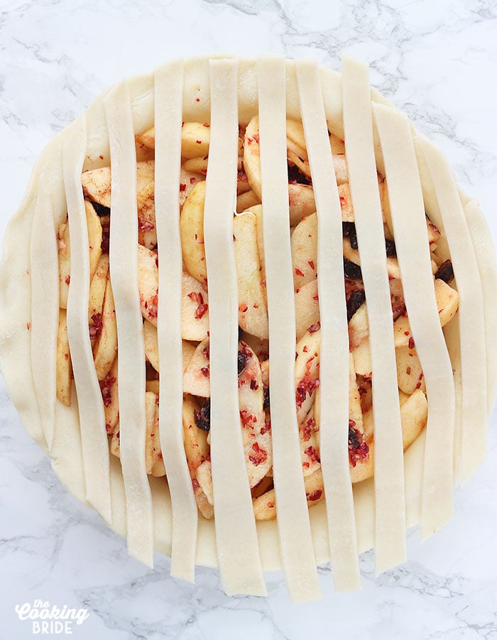 lattice pie strips arranged over an unbaked pie