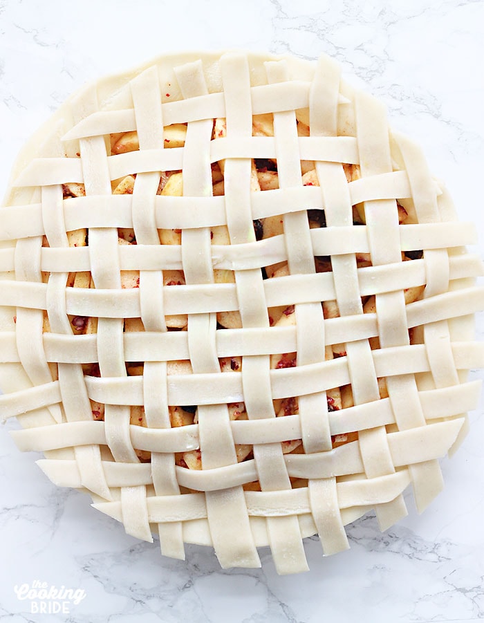 unbaked pie topped with a finished lattice crust
