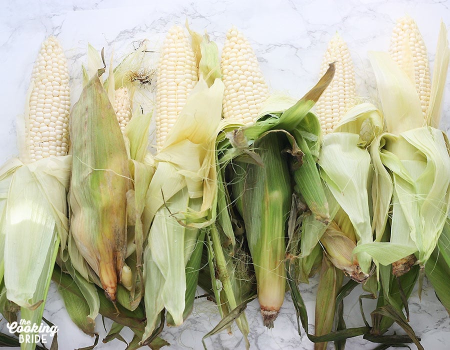 partially shucked ears of corn