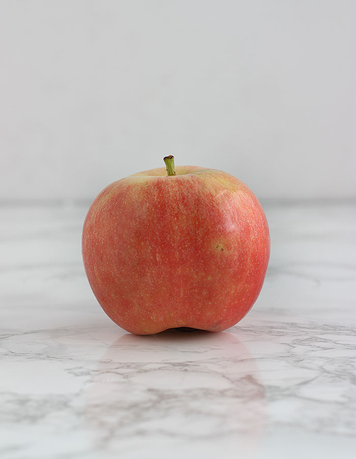 pink gala apple on a white background