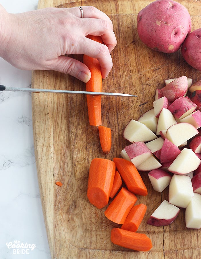 slicing carrots on a cutting board