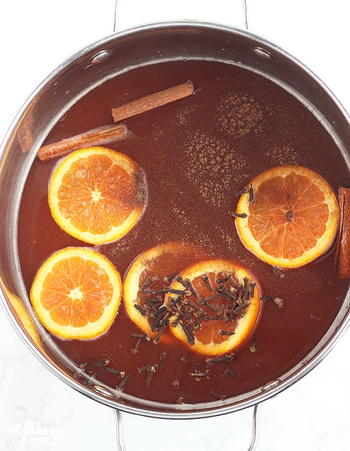 overhead shot of the apple cider ingredients in a large stock pot.