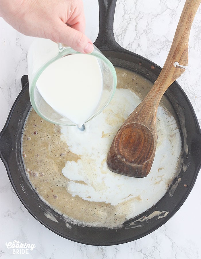 pouring milk into the skillet with the flour and drippings