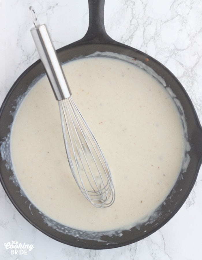 whisking the gravy until it has thickened
