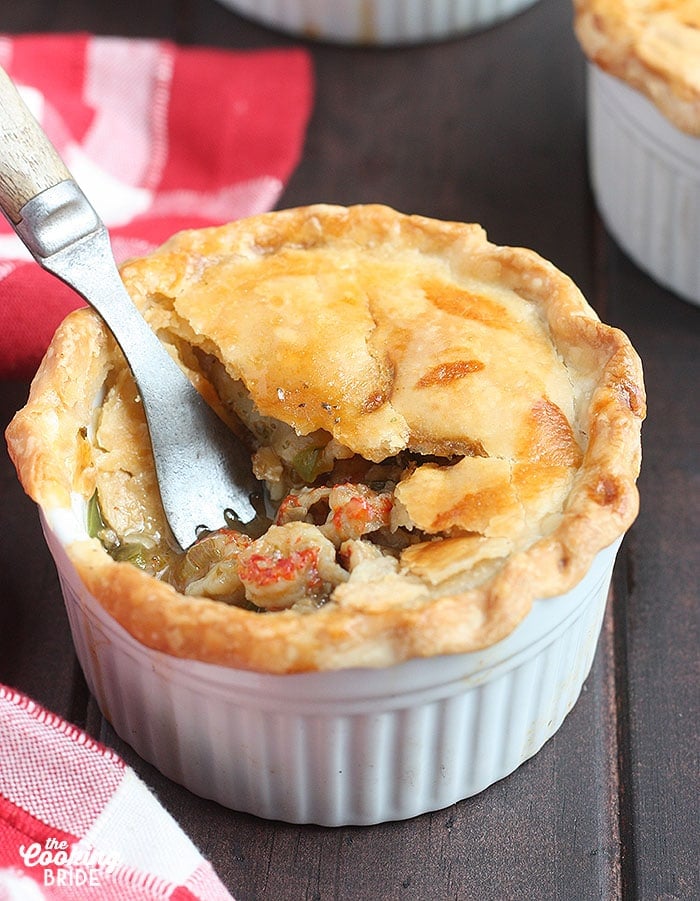 metal fork taking a bite out of a baked crawfish pie