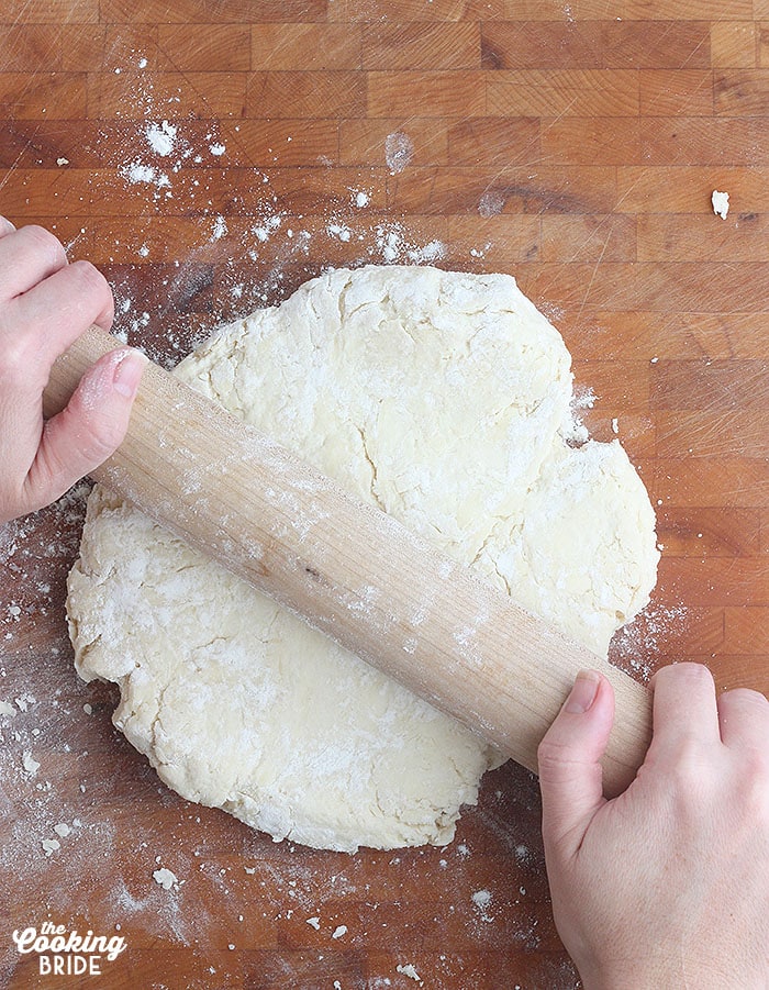 rolling out the biscuit dough with a rolling pin