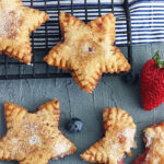 Star shaped fried pies cooling on a baking rack