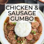 chicken and sausage gumbo with rice in a white bowl trimmed with green leaves