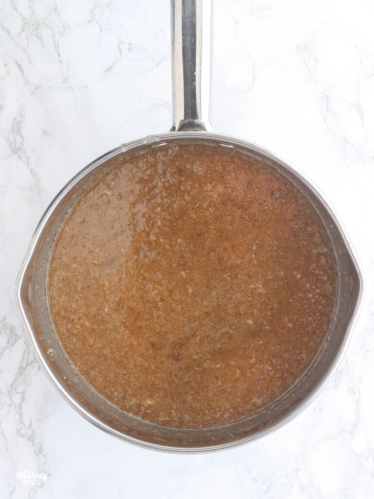 Jezebel sauce ingredients combined in a steel saucepan