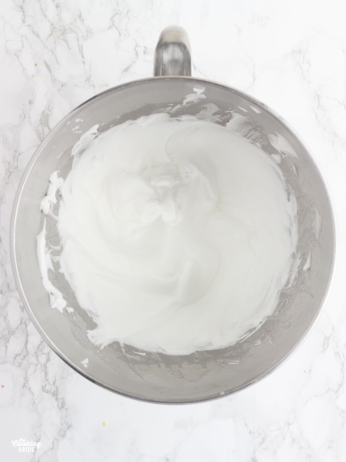 egg whites in a metal mixing bowl beaten until stiff peaks