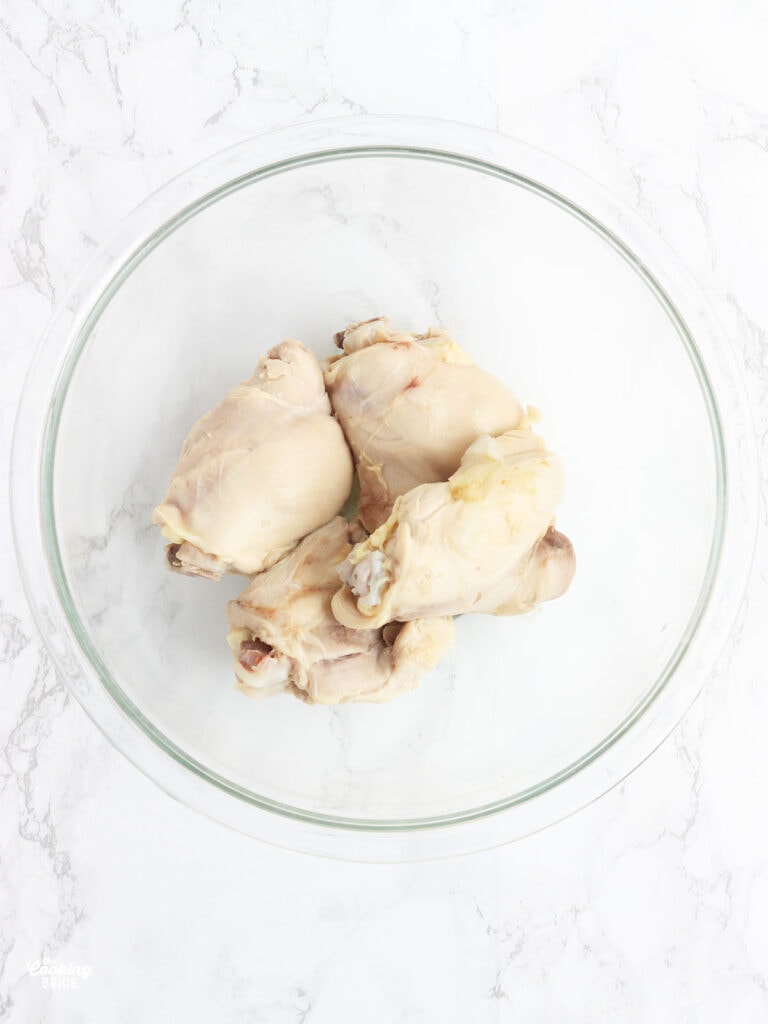 Cooked chicken cooling in a glass bowl