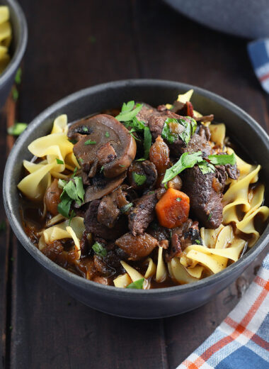 Venison bourguignon over egg noodles garnished with chopped parsley