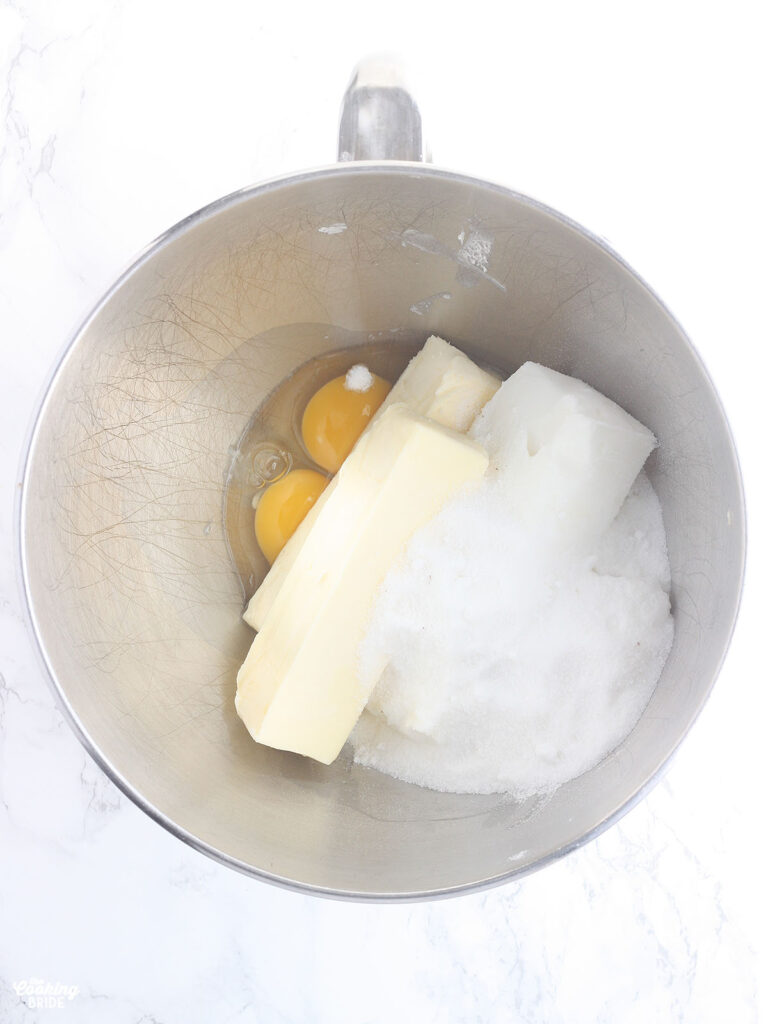 two eggs, butter, shortening and sugar in a metal mixing bowl