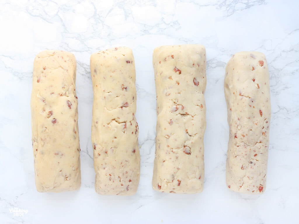 four logs of unbaked cookie dough